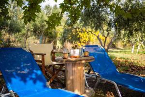 two chairs and a table and a table and chairs at Petalidi Sunny Home Two - Cozy Garden Escape in Petalidi