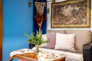a living room with a couch and a table at Petalidi Sunny Home One - Charming Garden Nest in Petalidi