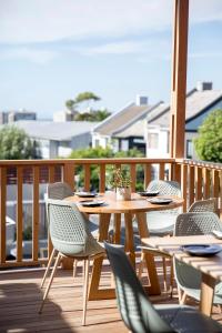 a wooden table and chairs on a deck at Antrim House by Totalstay in Cape Town +31 photos