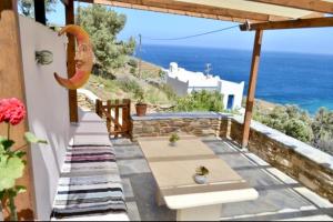 a patio with a view of the ocean at Φώς in Lichnaftia