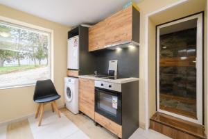 a small kitchen with a stove and a window at Veliko Turnovo Studios - Stylish & Convenient in Veliko Tŭrnovo