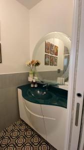 a bathroom with a sink and a mirror at Casa Margherita in Naples +14 photos
