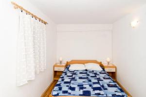 Postel nebo postele na pokoji v ubytování Apartments Žuronja