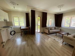 a living room with a couch and a table at Salegan Pansiyon in Uzungöl