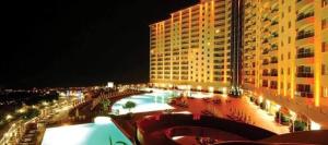a large building with a swimming pool at night at Goldctiy otel villa in Alanya +15 photos