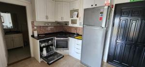 a kitchen with a refrigerator and an open oven at Goldctiy otel villa in Alanya