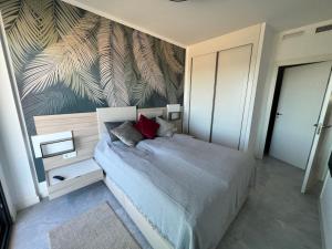 a bedroom with a bed with a mural of leaves at Camporrosso43 luxury penthouse, jacuzzi, billiards in Finestrat +161 photos
