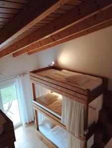 a room with two bunk beds in a room at Endless Summer Surf House in Aljezur