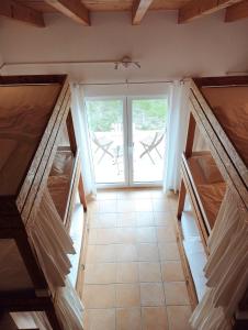 a room with a window and a tiled floor at Endless Summer Surf House in Aljezur