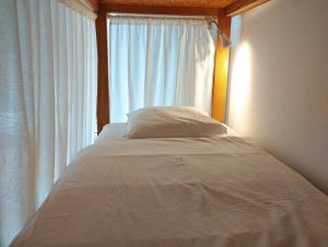 a bed in a room with a window at Endless Summer Surf House in Aljezur