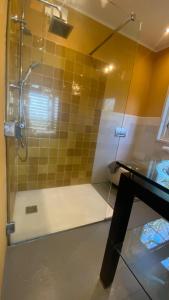 a bathroom with a shower with a glass door at B&B NR6 in Herbaijum +66 photos