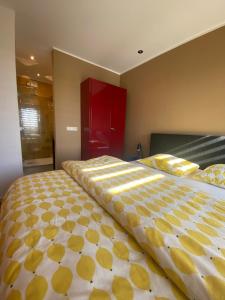 a large bed in a bedroom with a red cabinet at B&B NR6 in Herbaijum