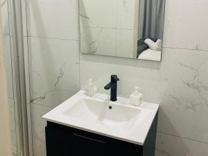a bathroom with a white sink and a mirror at Shengelezi Guest House in Jozini +18 photos