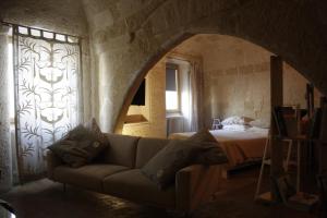 a living room with a couch and a bed at APN Holiday Home in Altamura