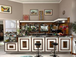 a bar with two stools in front of it at Hotel Rey in Turin