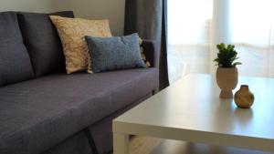 a couch and a table in a living room at Costa Adeje - Orlando apartments in Adeje +8 photos