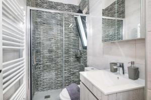 a bathroom with a sink and a glass shower at Villa Narciso in Souda +37 photos