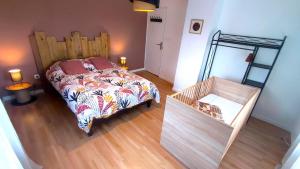a bedroom with a bed and a wooden floor at O naturel in Buzancy
