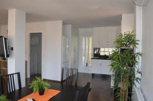 a kitchen and dining room with a table and plants at Casa Lucero in Rojales