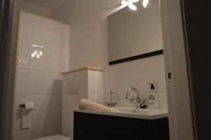 a white bathroom with a sink and a mirror at Casa Lucero in Rojales +12 photos