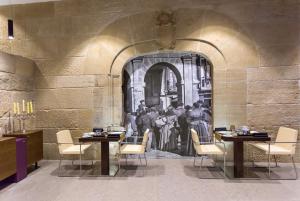 a dining room with a painting on the wall at Sercotel Calle Mayor in Logroño