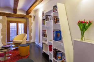 a room with white shelves and a yellow chair at Sercotel Calle Mayor in Logroño