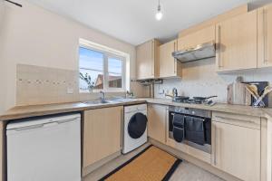 a kitchen with a sink and a dishwasher at Spacious 3BR Leicester Home, Sleeps 8, Free Parking, Fast WiFi, Long Stay & Contractors Welcome in Leicester
