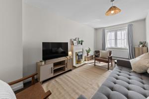 a living room with a couch and a flat screen tv at Spacious 3BR Leicester Home, Sleeps 8, Free Parking, Fast WiFi, Long Stay & Contractors Welcome in Leicester