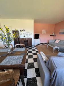 a living room with a couch and a table at Maison Pierre 3 bedroom house with swimming pool in Léon