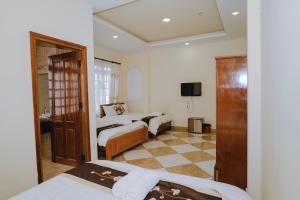 Postel nebo postele na pokoji v ubytování Nam Đông hotel