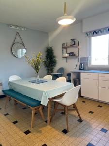 a kitchen and dining room with a table and chairs at Maison Pierre 3 bedroom house with swimming pool in Léon