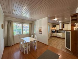 a kitchen and dining room with a table and chairs at Kotimaailma - House - Pietarsaari in Pietarsaari