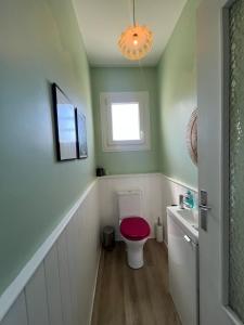 a bathroom with a toilet with a red seat at Maison Pierre 3 bedroom house with swimming pool in Léon +21 photos