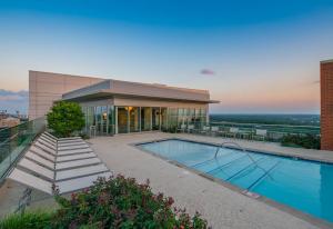 a building with a swimming pool in front of a building at Hala Tysons in McLean