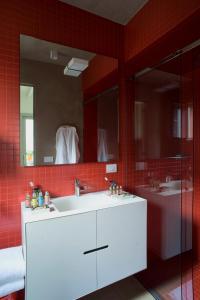 a bathroom with a white sink and a mirror at Milan Design Suites 3 ROOMS in Milan +3 photos