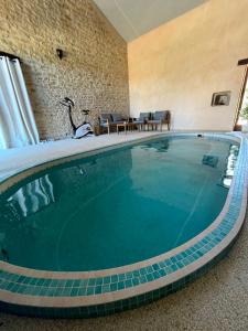 a swimming pool in a hotel room at La ferme des Soudanières in Ceyzériat