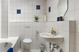 a white bathroom with a sink and a toilet at Obstbau Koch in Bodman-Ludwigshafen +34 photos