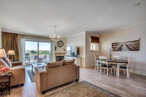 a living room with a couch and a table at Marina Inn Grande Dunes - 7-503 in Myrtle Beach