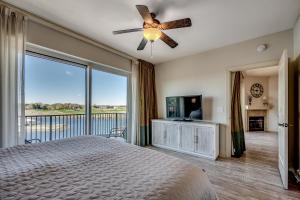 a bedroom with a bed and a ceiling fan at Marina Inn Grande Dunes - 7-503 in Myrtle Beach +37 photos