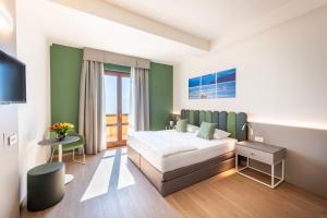 Postel nebo postele na pokoji v ubytování Hotel Pineta Campi