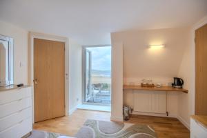a room with a door with a view of the ocean at The Penellen guest accommodation room only in Hayle