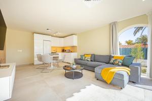 a living room with a couch and a table at LUXURY Sun Club 252 in San Bartolomé de Tirajana