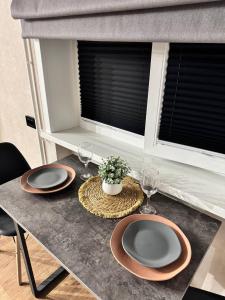 a table with two plates and wine glasses on it at Квартира 4-36 in Balqash +7 photos