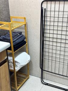 a shelf with towels on it next to a wall at Квартира 4-36 in Balqash