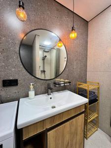 a bathroom with a sink and a mirror at Квартира 4-36 in Balqash