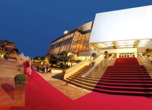 a red carpeted staircase in front of a building at Studio Cannes Californie in Cannes