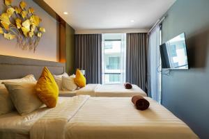 a hotel room with two beds and a television at View 2Bdr Lux Life Rawai in Rawai Beach +45 photos