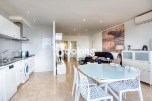 a kitchen and living room with a table and chairs at Kaminias Apartament amb vistes al mar reformat per 4 persones in Platja  d'Aro +14 photos