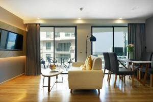 a living room with a couch and a table at View 2Bdr Lux Life Rawai in Rawai Beach