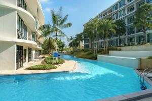 a swimming pool in front of a building at View 2Bdr Lux Life Rawai in Rawai Beach